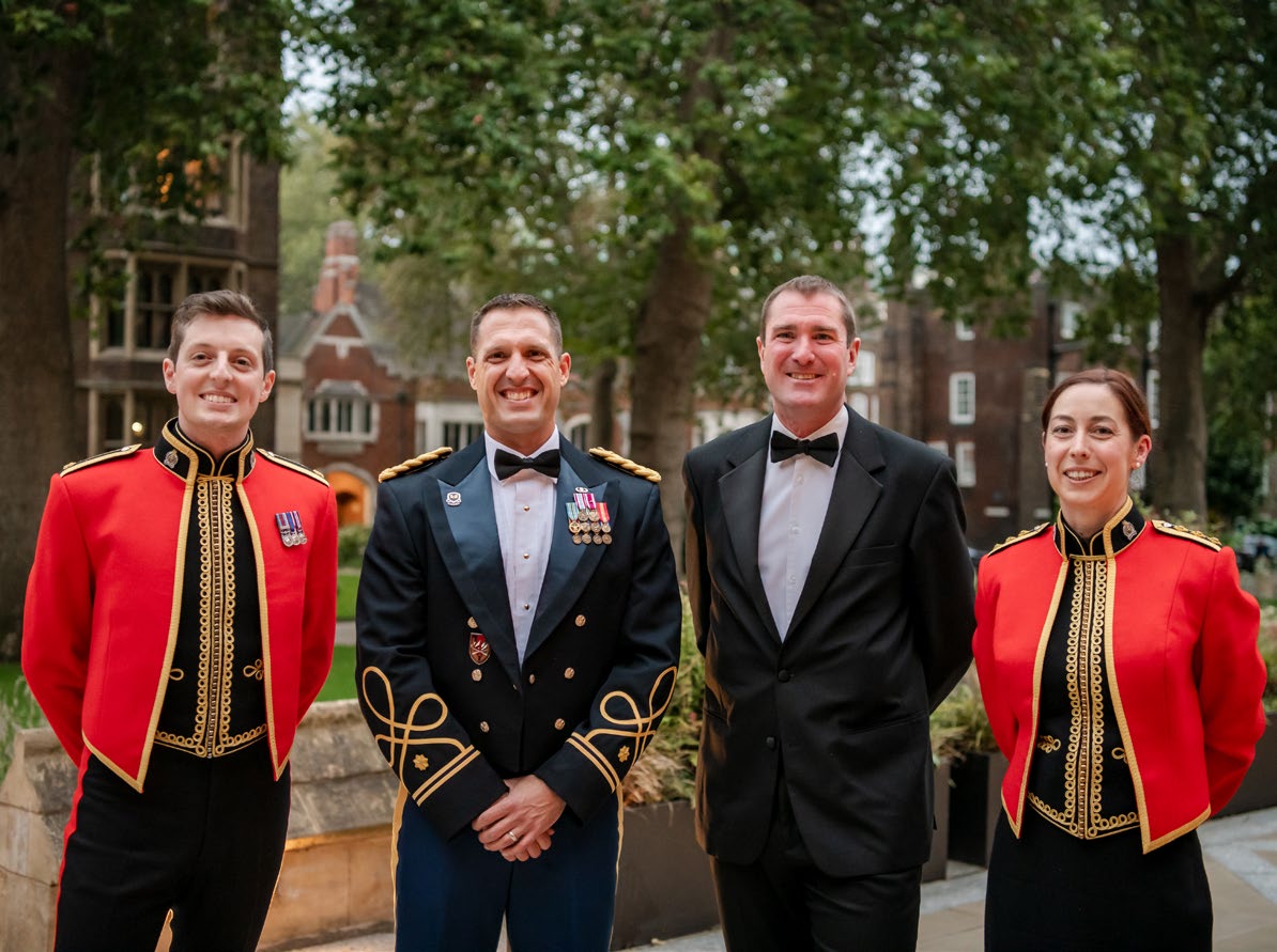 (From left to right) Maj. Steve Warburton, then-MAJ
      Chris Chatelain, Maj. James Trescothic-Martin,
      and Capt. Kathleen Brook attend the British Army
      Legal Services 75th Anniversary Dinner in London,
      England. (Photo courtesy of author)